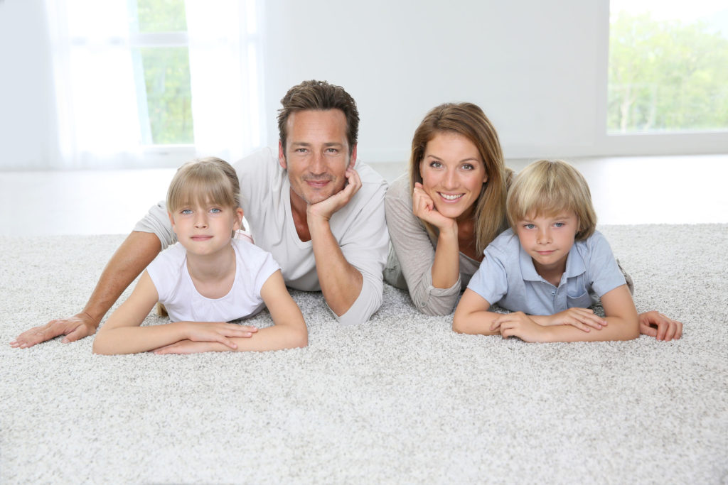 Family Laying On Carpet